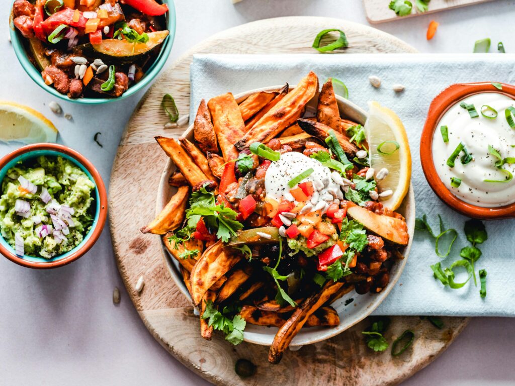 pexels-photo-1640772-1640772 A vibrant platter of savory sweet potato fries with fresh toppings, perfect for a tasty snack.