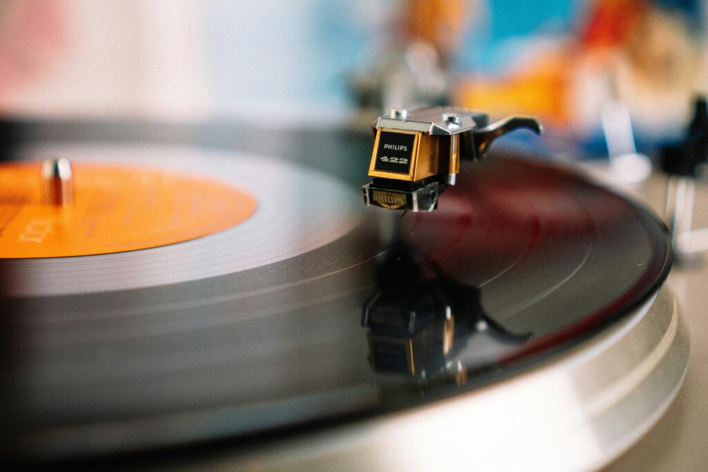 pexels-photo-4200747-4200747 A detailed close-up of a classic turntable needle playing a vinyl record, evoking nostalgia.